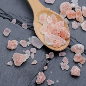 Himalayan pink salt crystals on a wooden spoon